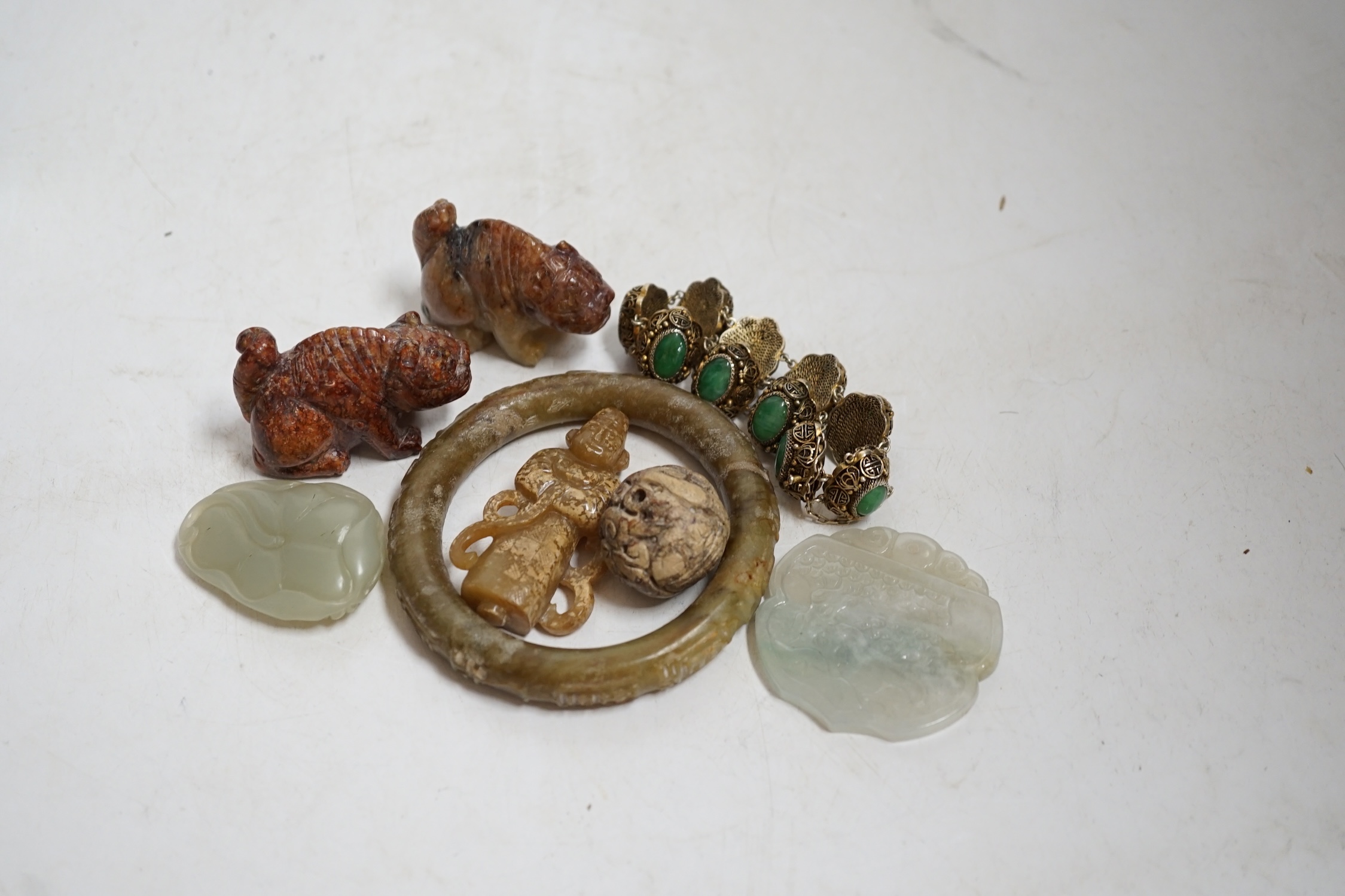 Sixteen Chinese jade and hardstone carvings, including a gilded white metal and jadeite bracelet, three pendants etc. Condition - fair